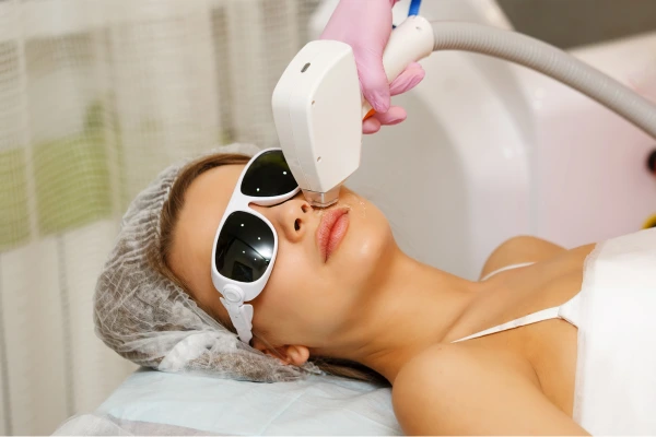 A therapist performing facial hair laser hair removal treatment
