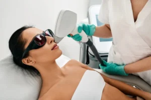 An experienced therapist performing laser hair removal session