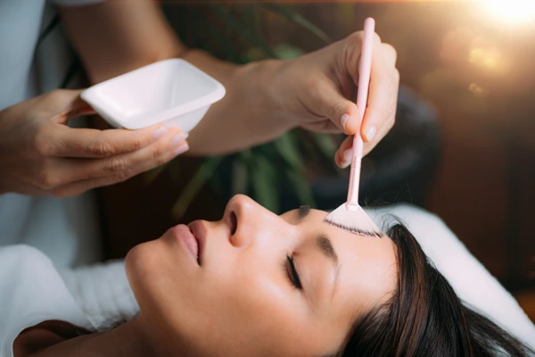A dermatologist performing chemical peel treatment