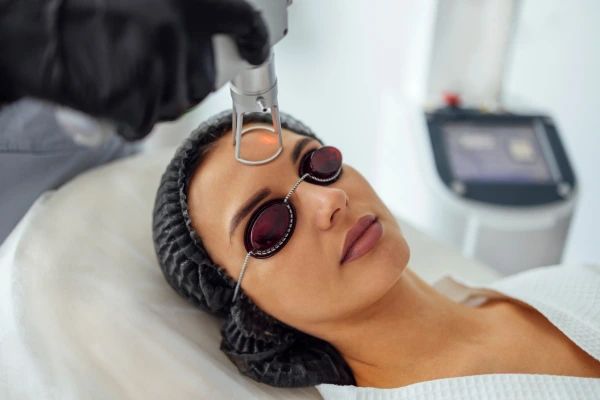 A dermatologist performing laser resurfacing treatment