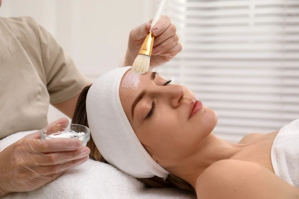 A dermatologist performing chemical peel treatment