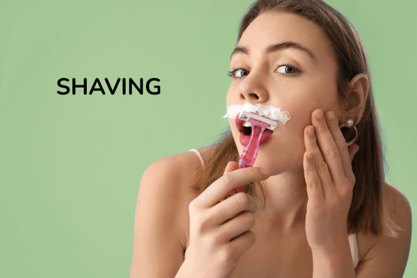 A women getting shaved her facial hair